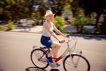 Happy young woman cycling