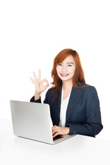 Asian office girl show OK sign with notebook PC