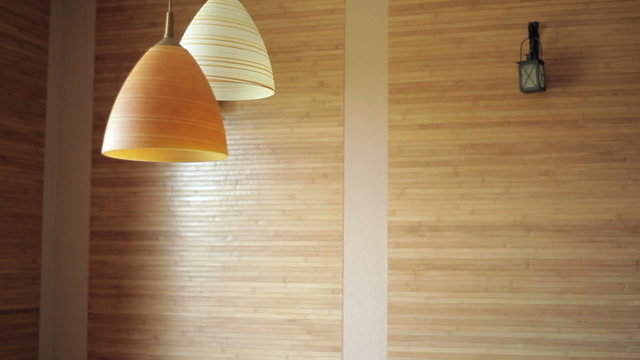two beautiful chandeliers on the background of wooden wall