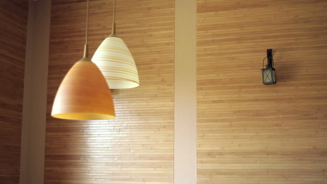 two beautiful chandeliers on the background of wooden wall