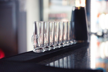 Row of glass shots at bar