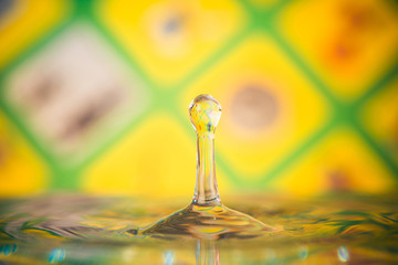 small liquid drop at colorful background