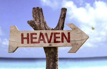 Heaven wooden sign with a beach on background