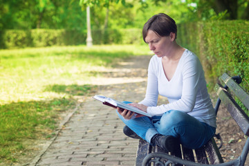 Woman reading book in the park