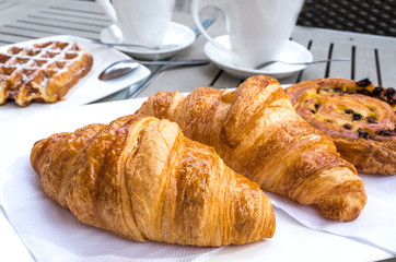 coffee and croissants on table