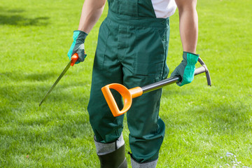 Gardener's hands with garden tools