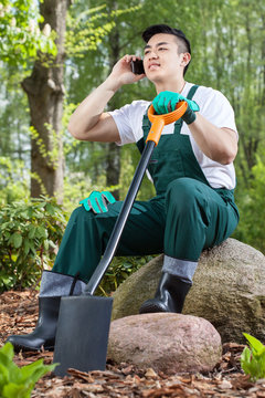 Gardener Resting, Talking On The Phone