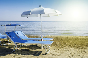 Fototapeta na wymiar Sunbeds and umbrellas on the beach