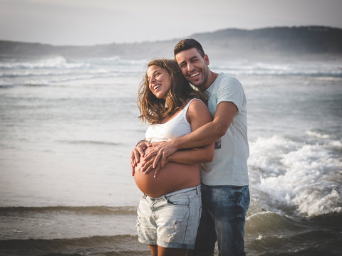 Pregnant couple on beach