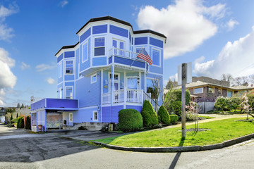 Big bright blue house with american flag