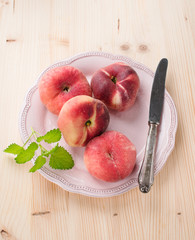 ripe juicy chinese flat peaches or Saturn peaches