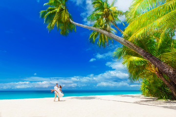 Dream scene. young loving happy couple on tropical beach with pa
