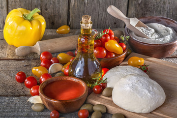 Dough for Italian pasta with tomato, olive oil and vegetables