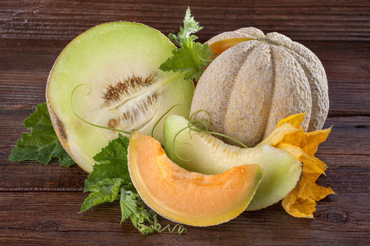 Fresh domestic cantaloupe melon on a wooden background
