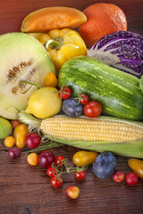 Fresh fruits and vegetables on a wooden background