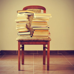 books on a chair, with a retro effect - obrazy, fototapety, plakaty