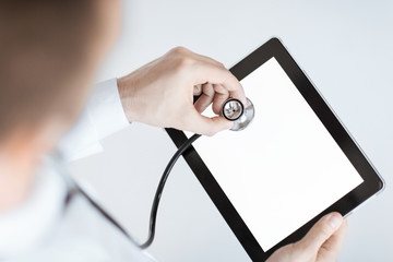 doctor with stethoscope and tablet pc