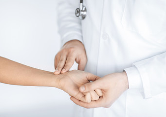 doctor measuring patient heart beat