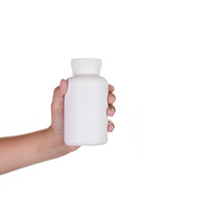 Hand holding upplements or  vitamin bottle