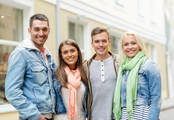 Fototapeta premium group of smiling friends in city