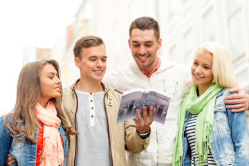 group of friends with city guide exploring town