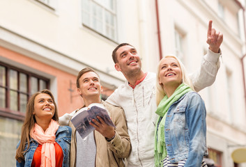 group of friends with city guide exploring town