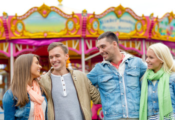 Obraz premium group of smiling friends in amusement park