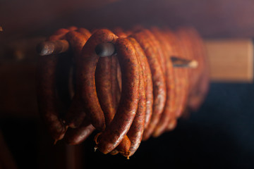Traditional food. Smoked sausuages in smokehouse. - obrazy, fototapety, plakaty