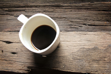 white coffee cup on the old wooden floor