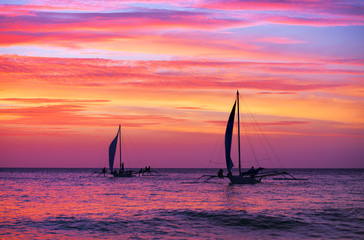 Two sailing boat in the beautiful sunset