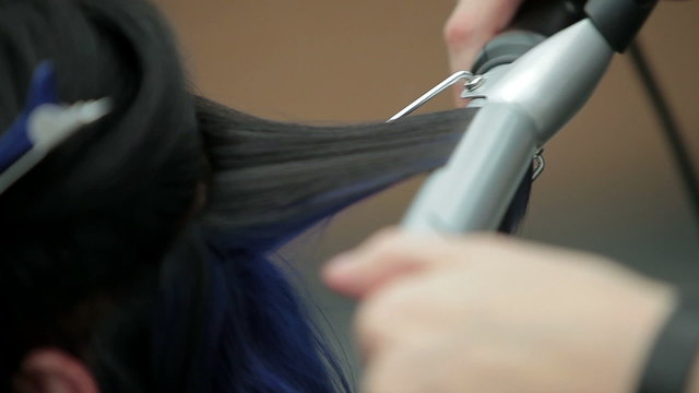 Hairdresser makes perm curling