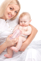 Obraz na płótnie Canvas young mum feeding small baby.