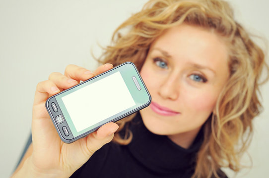 Businesswoman showing mobile phone