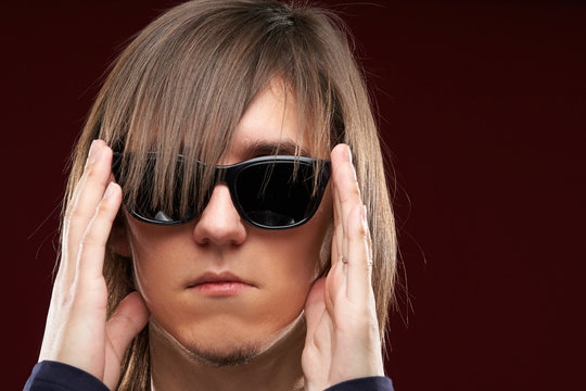 Portrait of a hairy man in black glasses
