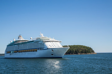 Fototapeta na wymiar Cruise Ship by Green Island on Blue Water