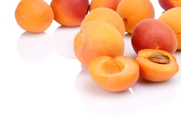 Several sliced apricots isolated on white