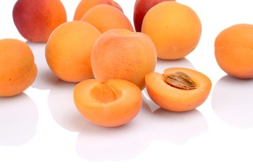 Several sliced apricots isolated on white