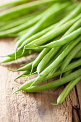 fresh green beans over wooden background