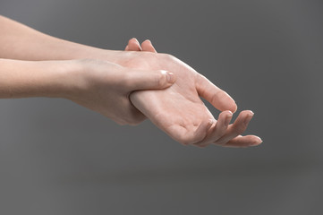 Woman holding her wrist - pain concept.