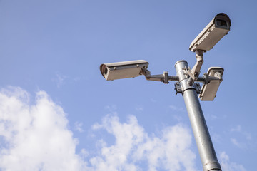 security cameras against blue sky