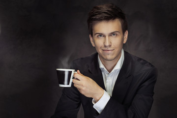 Portrait of the handsome mna holding the coffee cup
