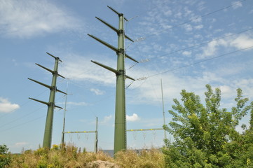 High voltage electric towers against blue sky