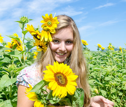 Happiness: Young pretty woman in sunflower field :)