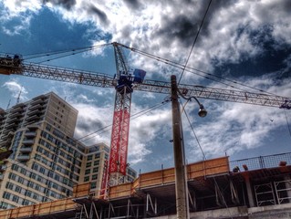 Dark clouds over high-rise building under construction