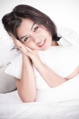 Portrait of a beautiful young woman in bed