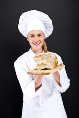 Chef baker smailing, fresh baked bread.