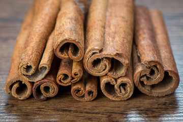 Essential cinnamon for spa, close up on wooden table
