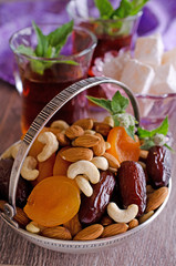 almonds, dried apricots, cashews, dates, lying in a metal bowl