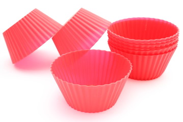 Red silicone cups on white background