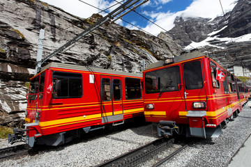 Famous electric red tourist train coming down from the Jungfraujoch station, Bernese Oberland, Switzerland, Europe